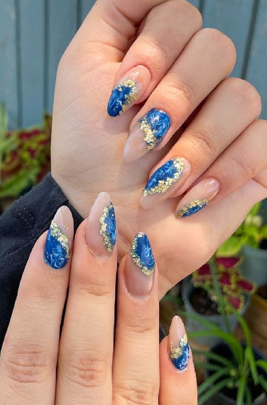 Almond blue and gold nails